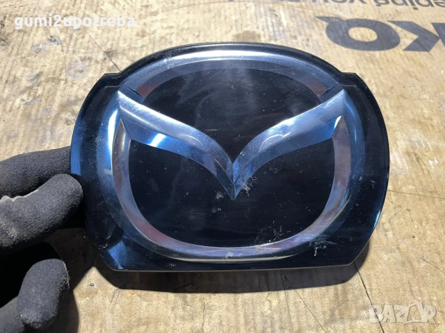 Емблема пред Радара B45F-51731 Mazda3 2014 2.0бен 121kW