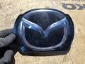 Емблема пред Радара B45F-51731 Mazda3 2014 2.0бен 121kW, снимка 1