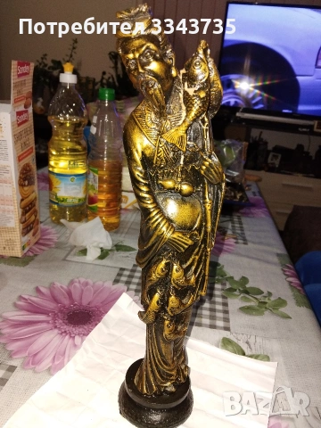 Китайска статуетка,изобразяваща рибар,често свързана с добър късмет.